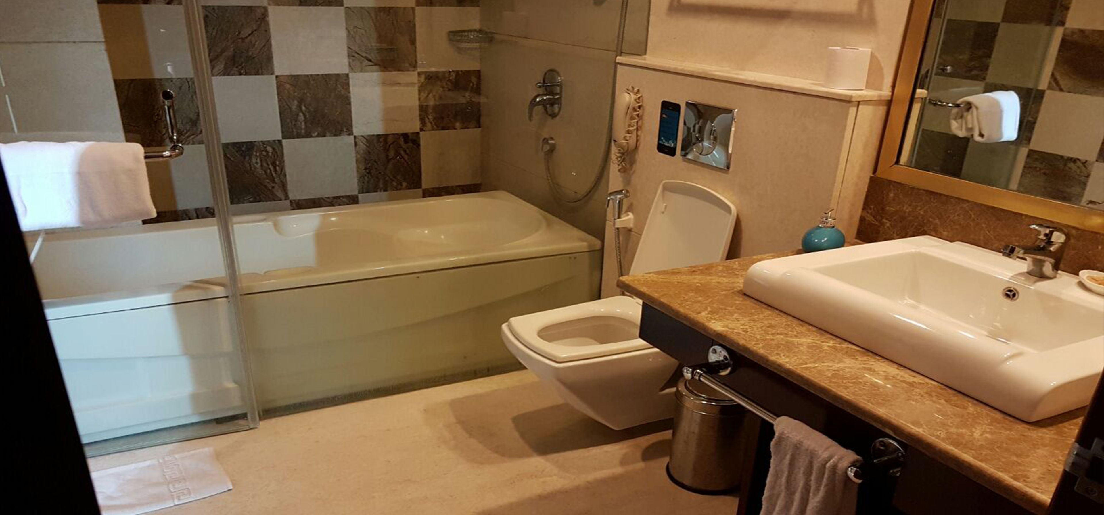 A bathroom with a bathtub, toilet, and sink.