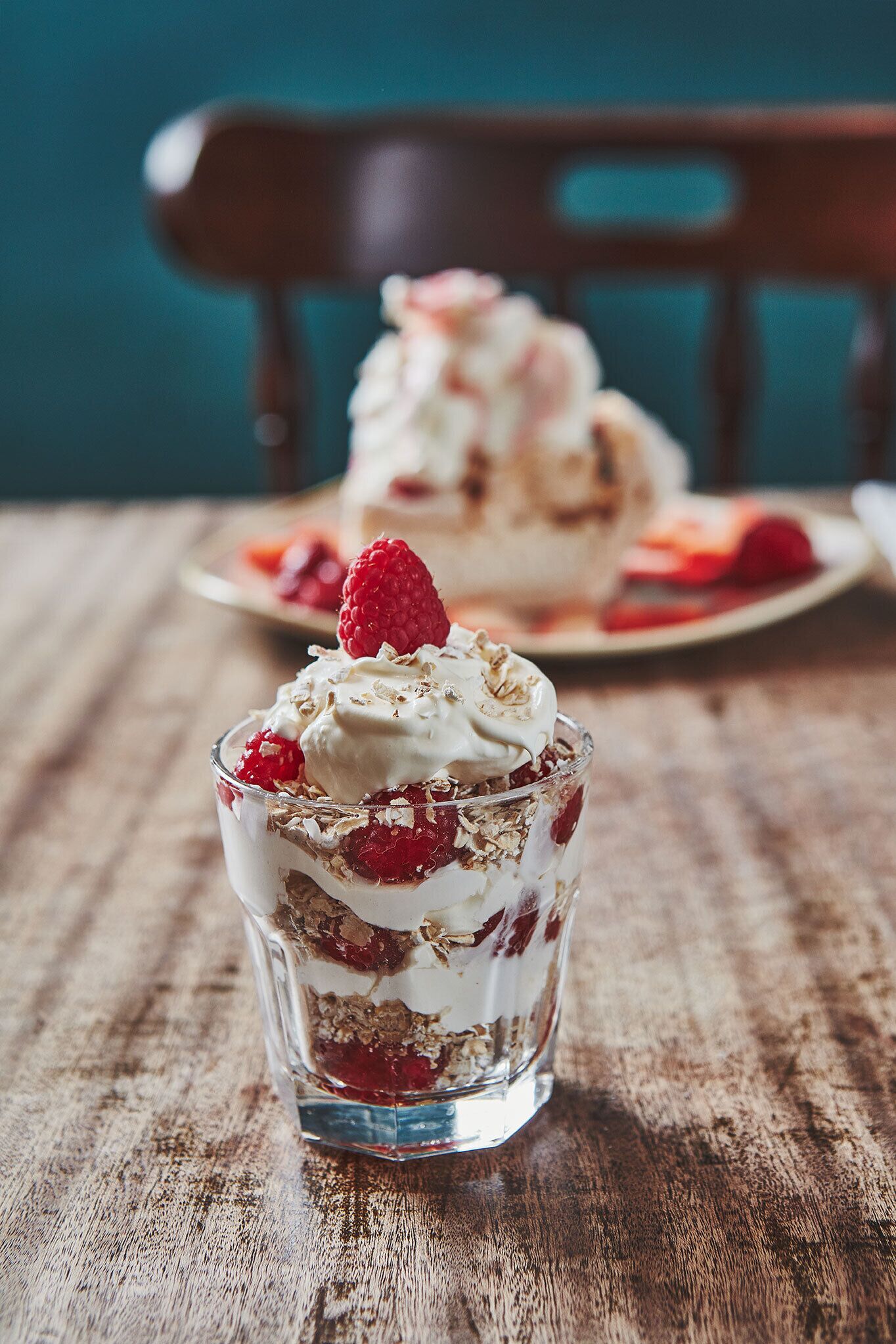 A dessert in a glass on a wooden table.