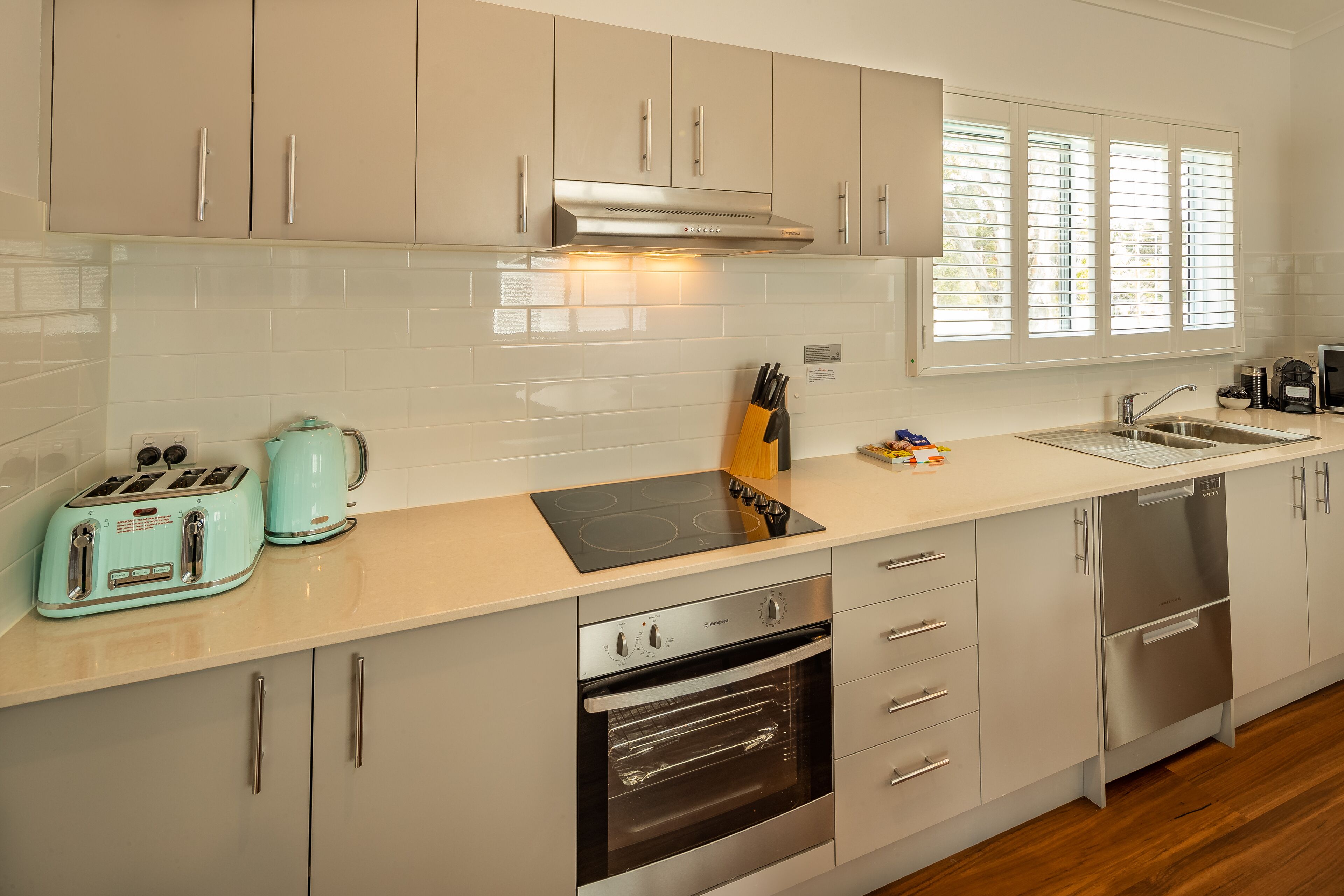 A modern kitchen with stainless steel appliances, a toaster, and a coffee maker.