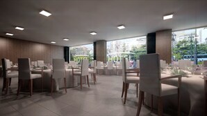 A modern hotel dining area with multiple tables and chairs, large windows offering a city view, and recessed ceiling lighting. - Sercotel Aura Algeciras (Algeciras)
