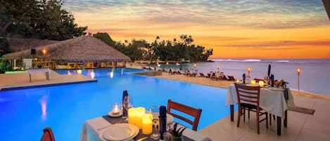 Alberca al aire libre, sombrillas en la alberca y camastros