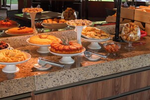 A buffet with various desserts and pastries.