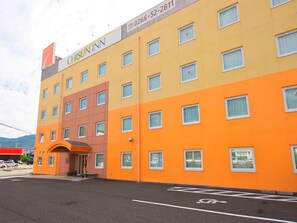 Experience the vibrant colors of CHISUN INN, a modern building with a variety of rooms and convenient parking.