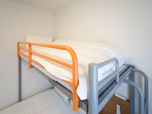 A bunk bed with an orange frame and white bedding. - Comfort Inn Munakata (Munakata)