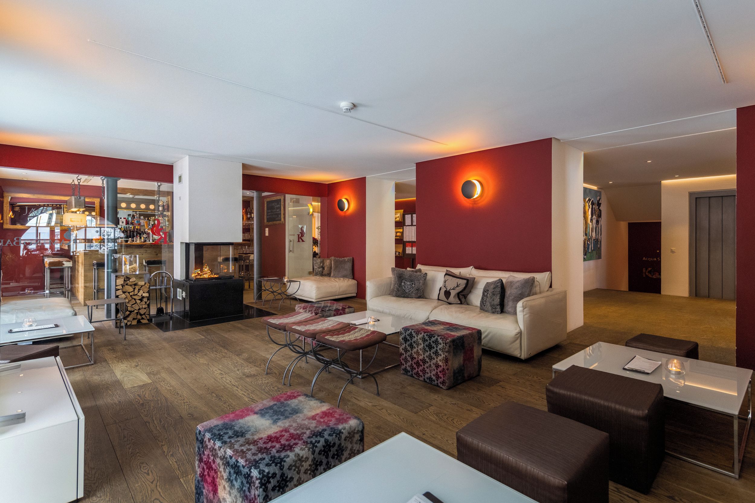 A modern living room with a fireplace, a sofa set, and a dining area.