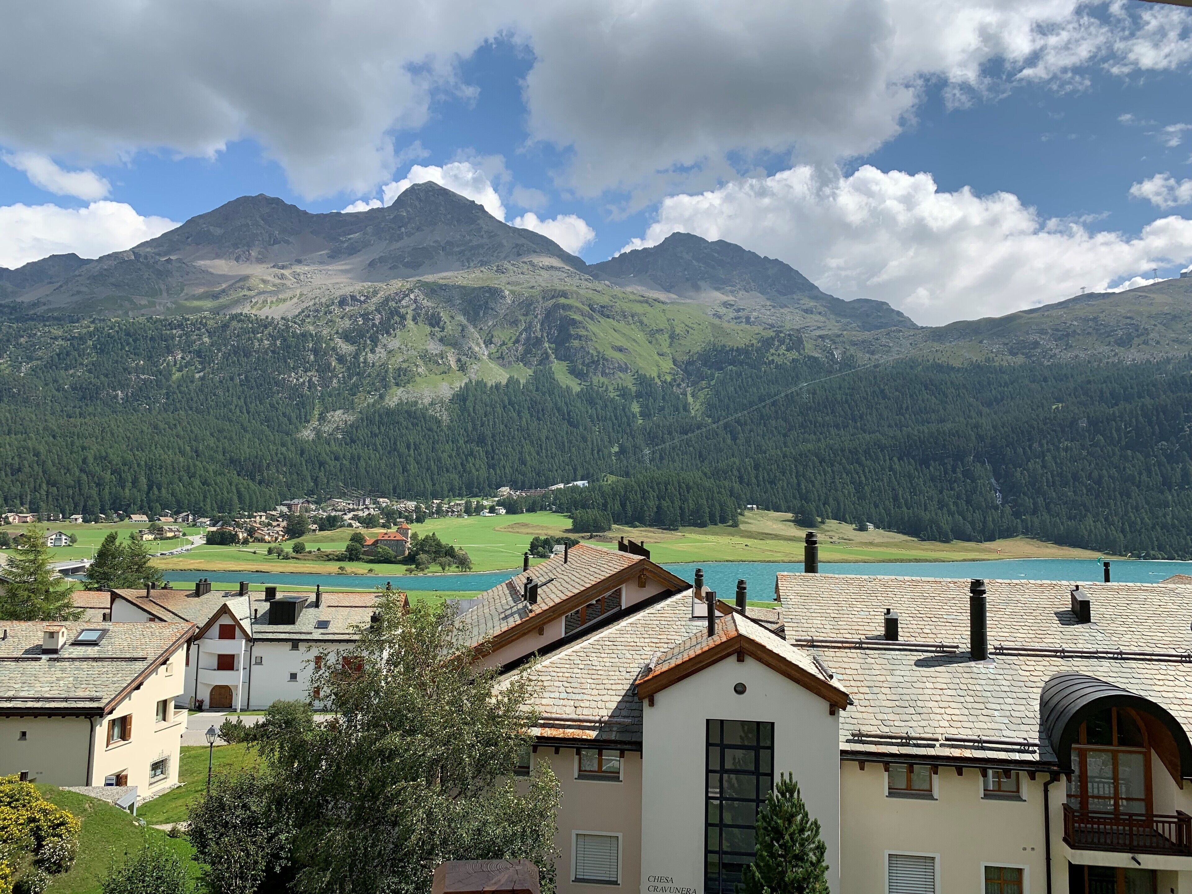 A mountain landscape with a lake and a village.