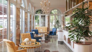 A luxurious interior with a chandelier, seating area, and large windows. - Hotel Fürstenhof Bad Bertrich (Bad Bertrich)