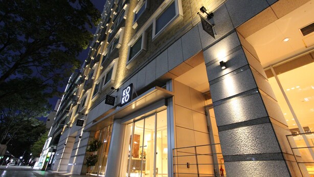 A modern building with a glass storefront and a sign that reads "KOKO". - KOKO HOTEL Sendai Kotodai Park (Sendai)