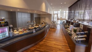 A buffet area with various food stations, a refrigerator with beverages, and a coffee station. - KOKO HOTEL Sendai Kotodai Park (Sendai)