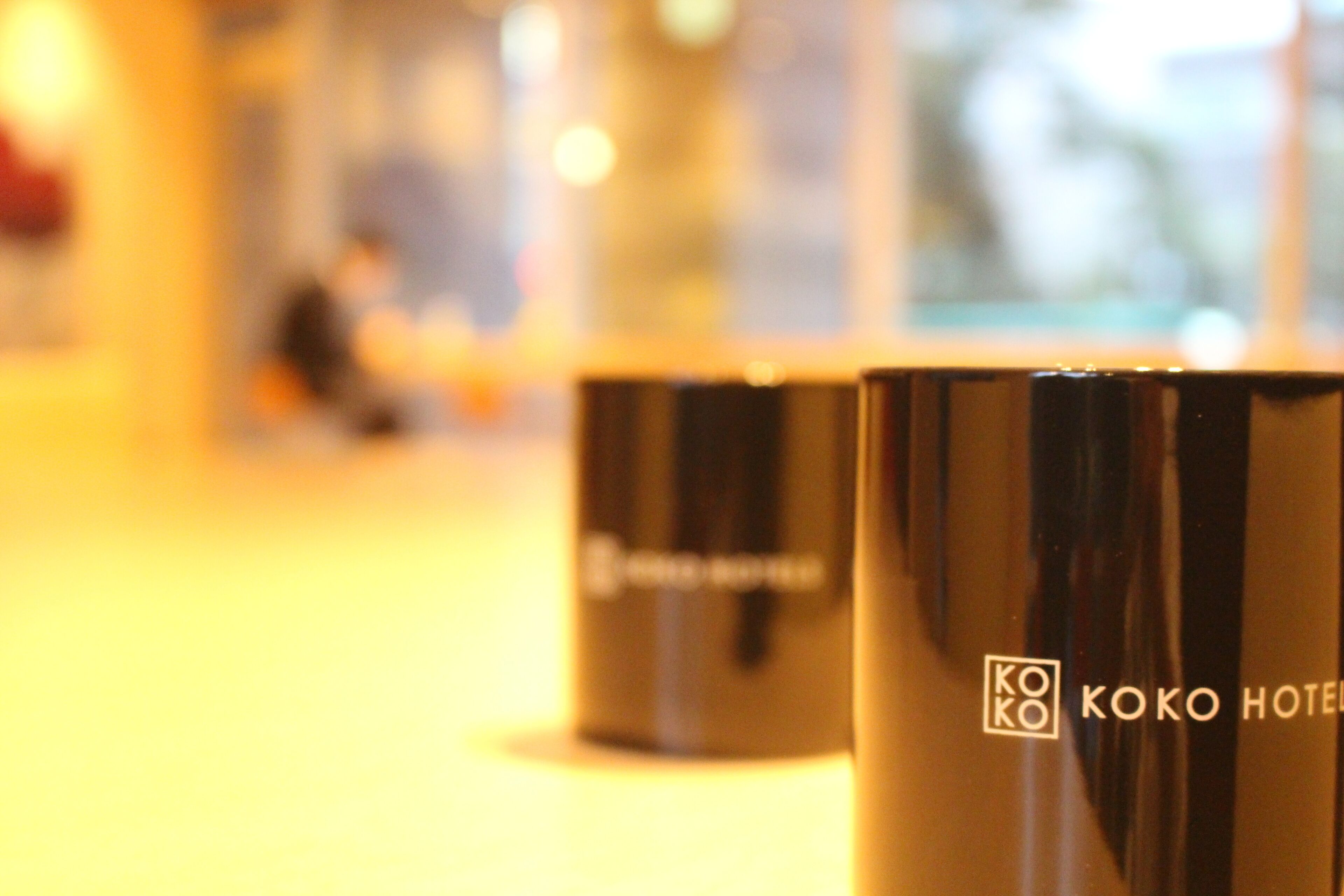 Two black hotel mugs with the "KOKO HOTEL" logo.