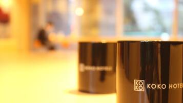 Two black hotel mugs with the "KOKO HOTEL" logo.