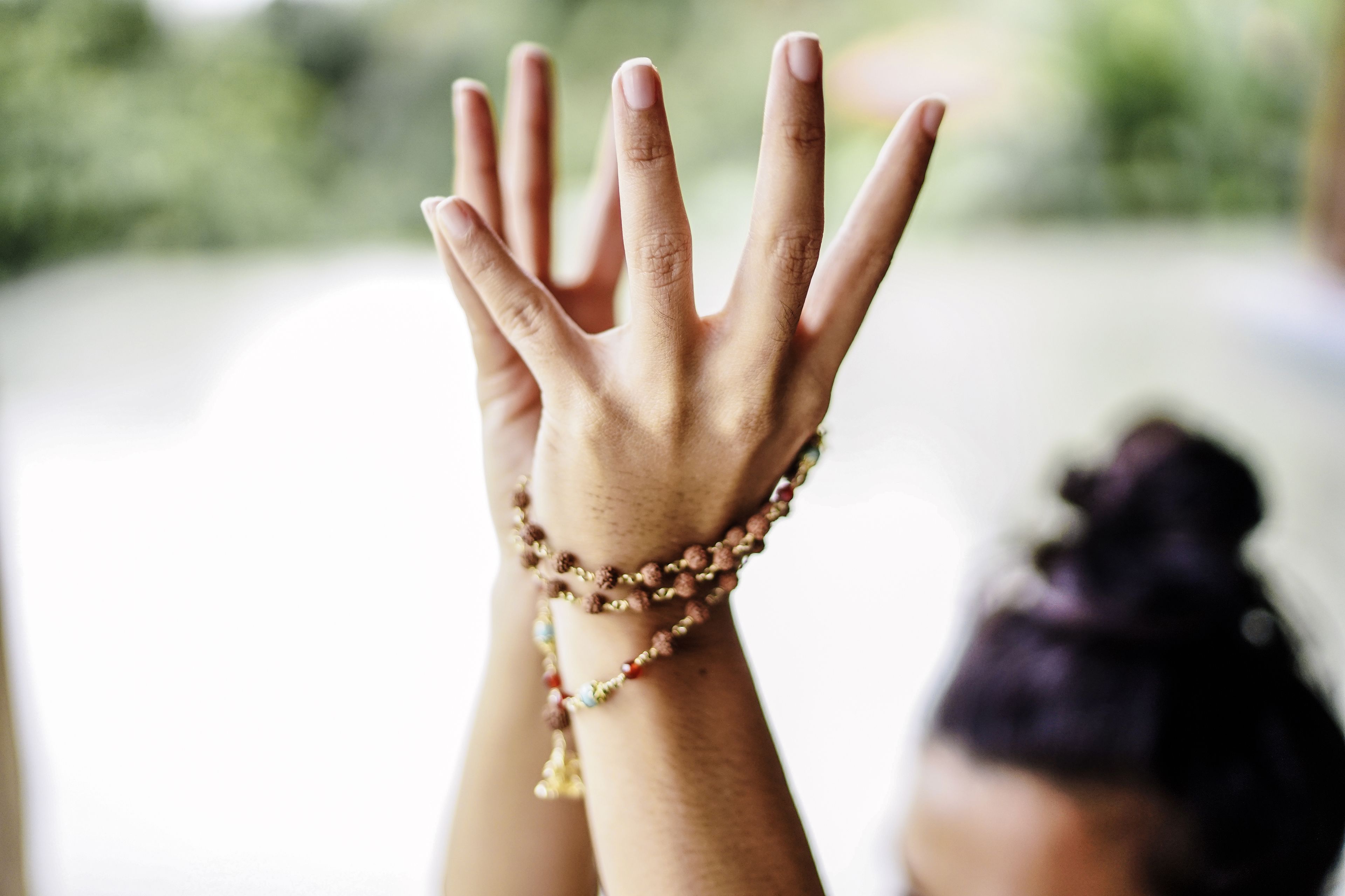 Une main ornée de plusieurs bracelets.