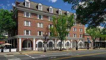 A multi-story brick building with arched windows and a flat roof.