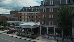 A multi-story building with a brick facade and a flat roof.