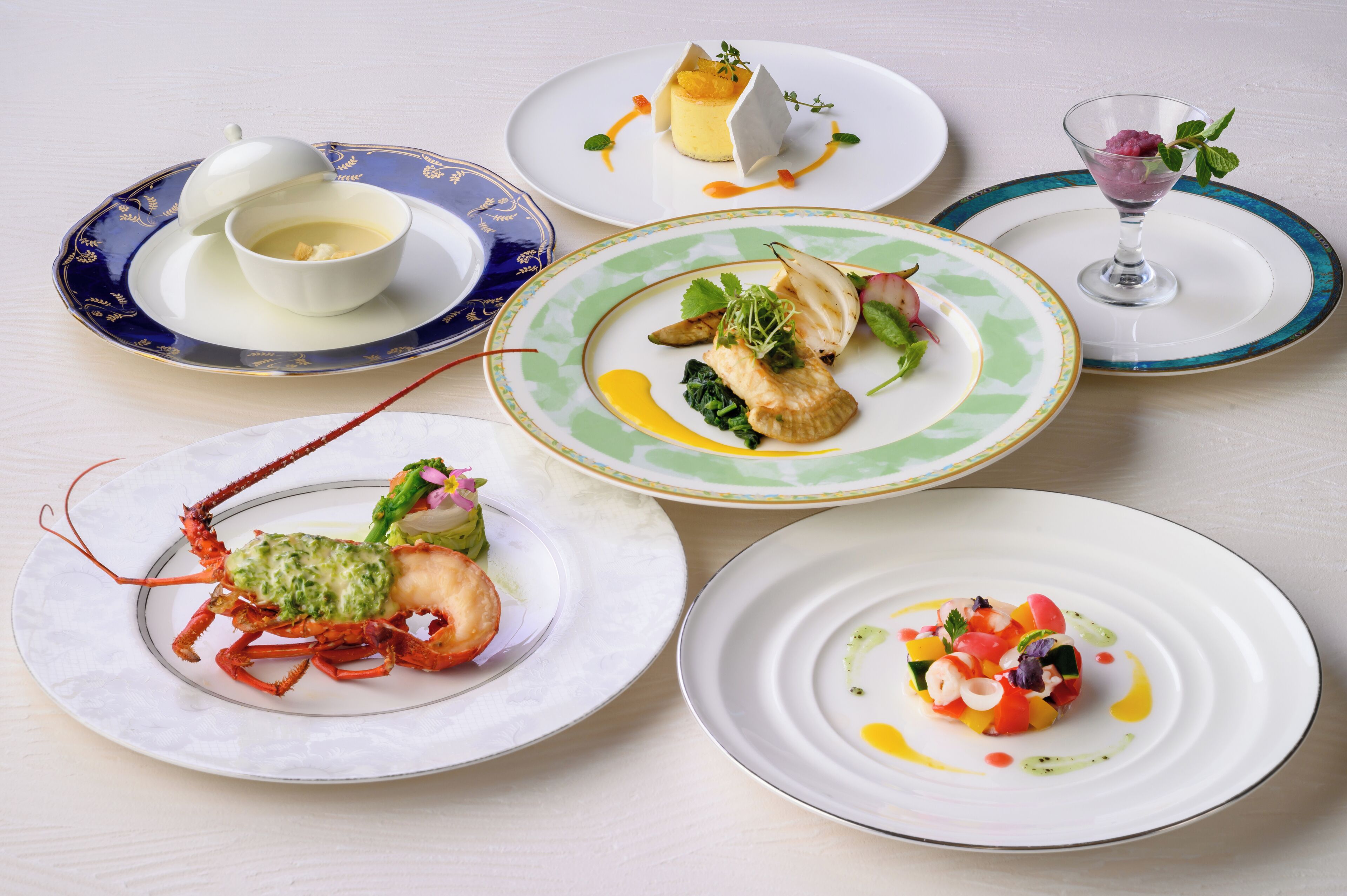 A variety of dishes on plates, including seafood and salads.