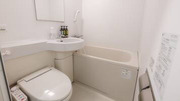 A small, white bathroom with a toilet, sink, and bathtub.