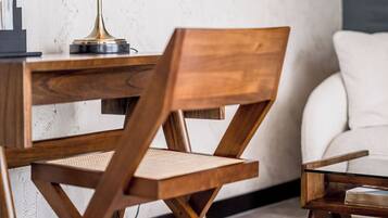 A modern room with a wooden desk, a chair, and a lamp.