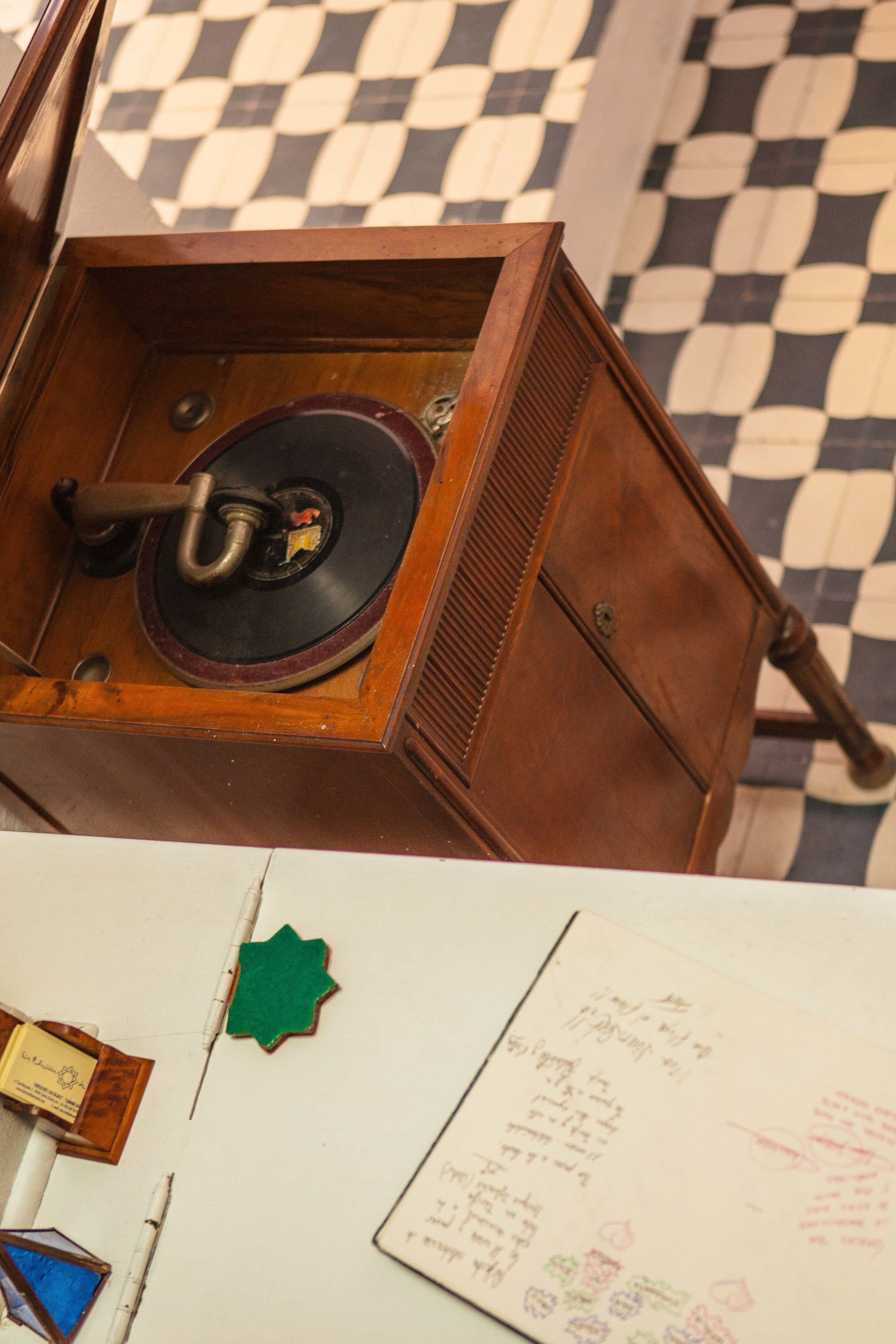 A vintage record player in a wooden cabinet.