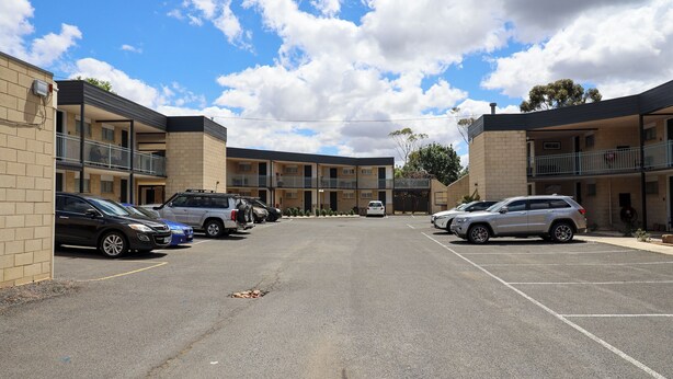 A multi-story parking garage with several cars parked.