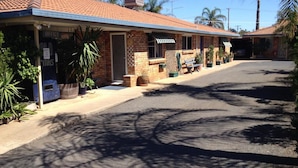 A two-story motel with a brick facade, a covered porch, and a parking area. - Bellview Motel (Narrabri)