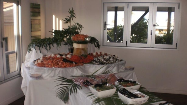 A buffet table with various dishes and a decorative centerpiece. - Blackwater Hotel Motel (Blackwater)