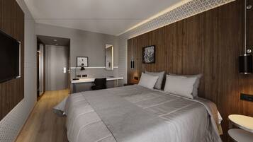 A modern bedroom with a large bed, a desk, and a mirror.