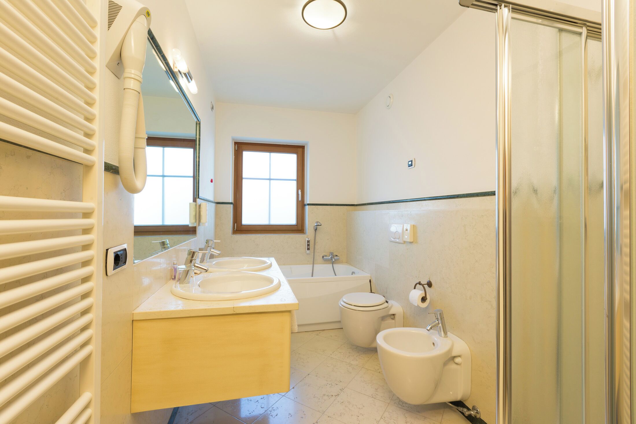 A bathroom with a bathtub, toilet, and sink.
