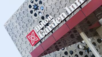 A hotel sign with a geometric facade and a star emblem.