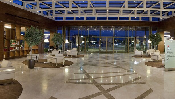 A spacious lobby with a high ceiling, modern furniture, and a central open area. - Hilton Garden Inn Konya, Turkey (Konya)