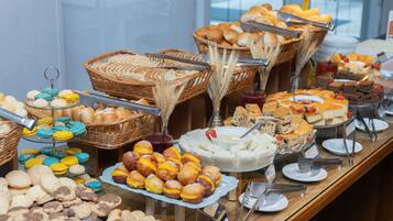 A buffet with various baked goods and desserts.