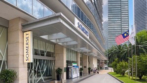 A modern building with a sign reading 'SOMERSET' and a Malaysian flag. - Somerset Kuala Lumpur (Kuala Lumpur)