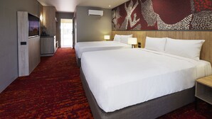 A hotel room with two beds, a kitchenette, and a red carpeted floor. - The Outback Hotel (Yulara)