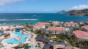 A resort with a central pool, multiple guest rooms, and a view of the ocean. - Marriott's St. Kitts Beach Club (Basseterre)