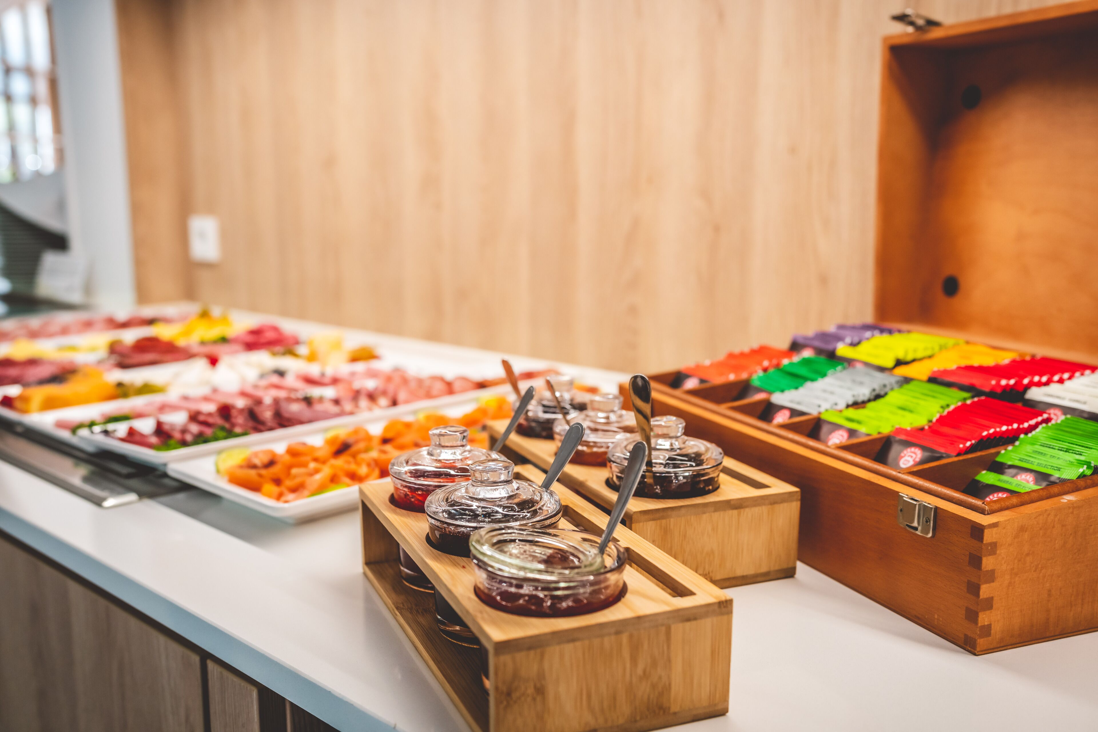 A buffet with various food items and condiments.