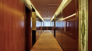 A long, narrow hallway with wooden walls and doors, leading to a room with a large window. - Hongfeng Hotel Shenzhen (Shenzhen)