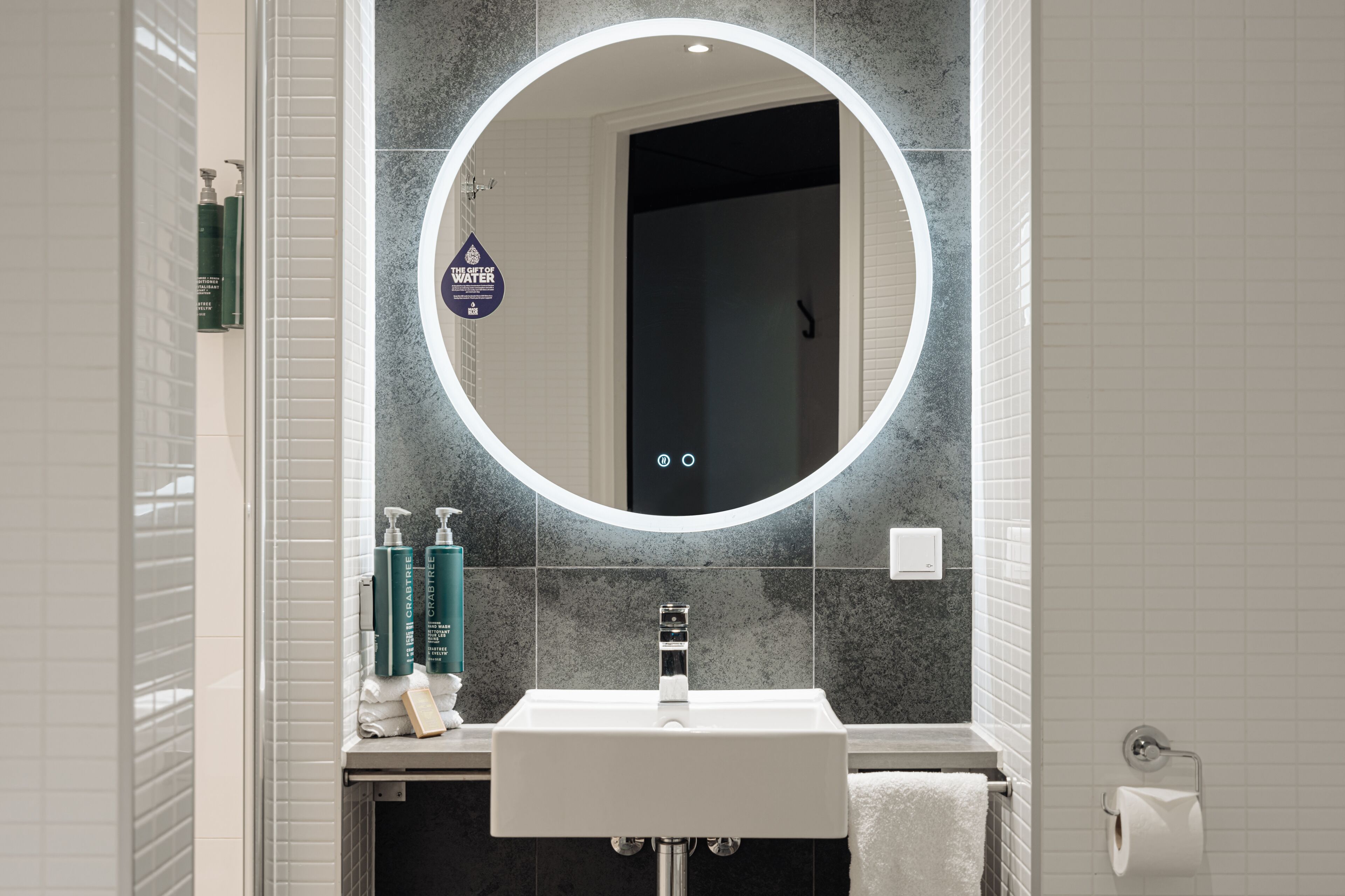 one bedroom suite with city view | bathroom | shower, designer toiletries, hair dryer, slippers