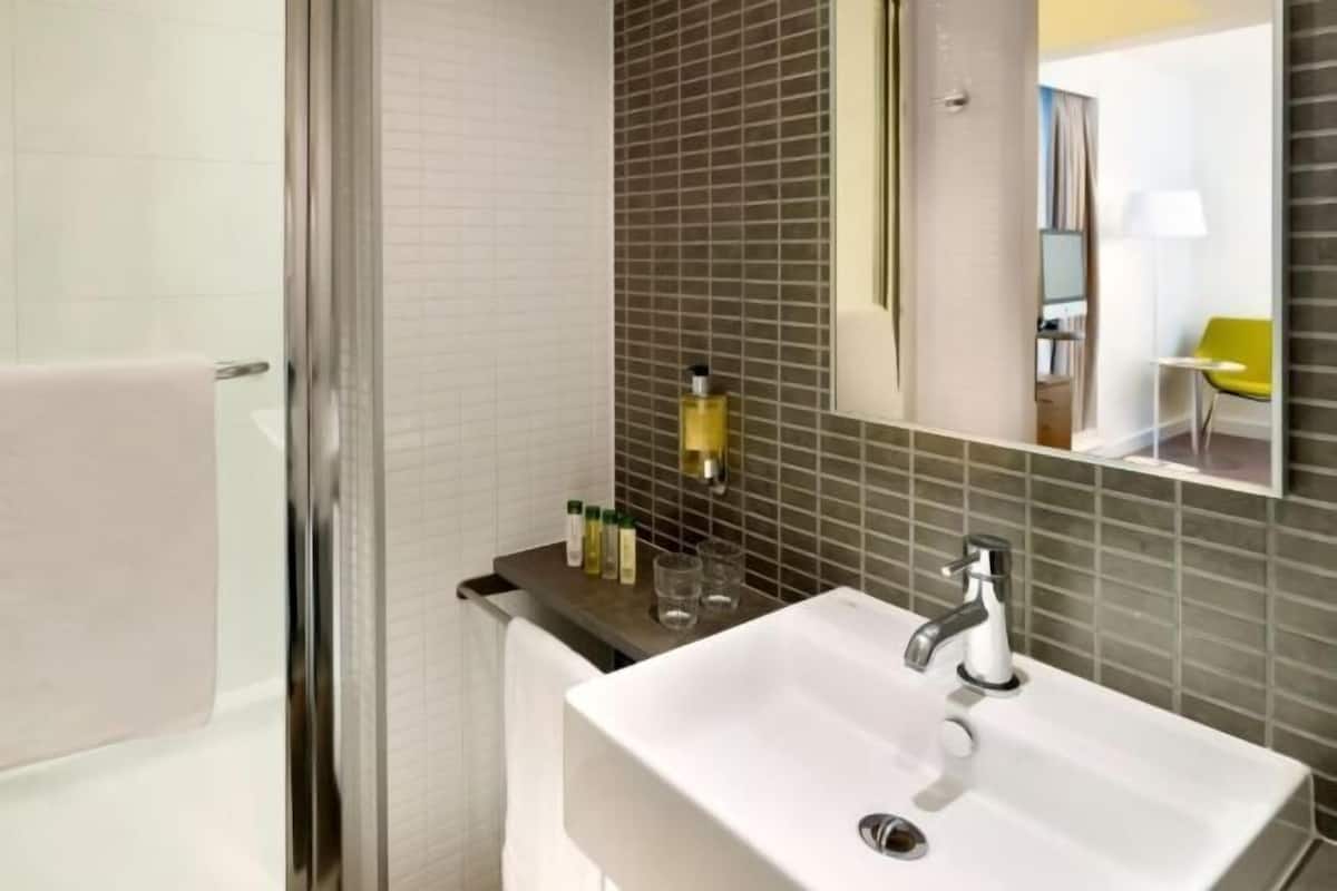 Shower, designer toiletries, hair dryer, towels