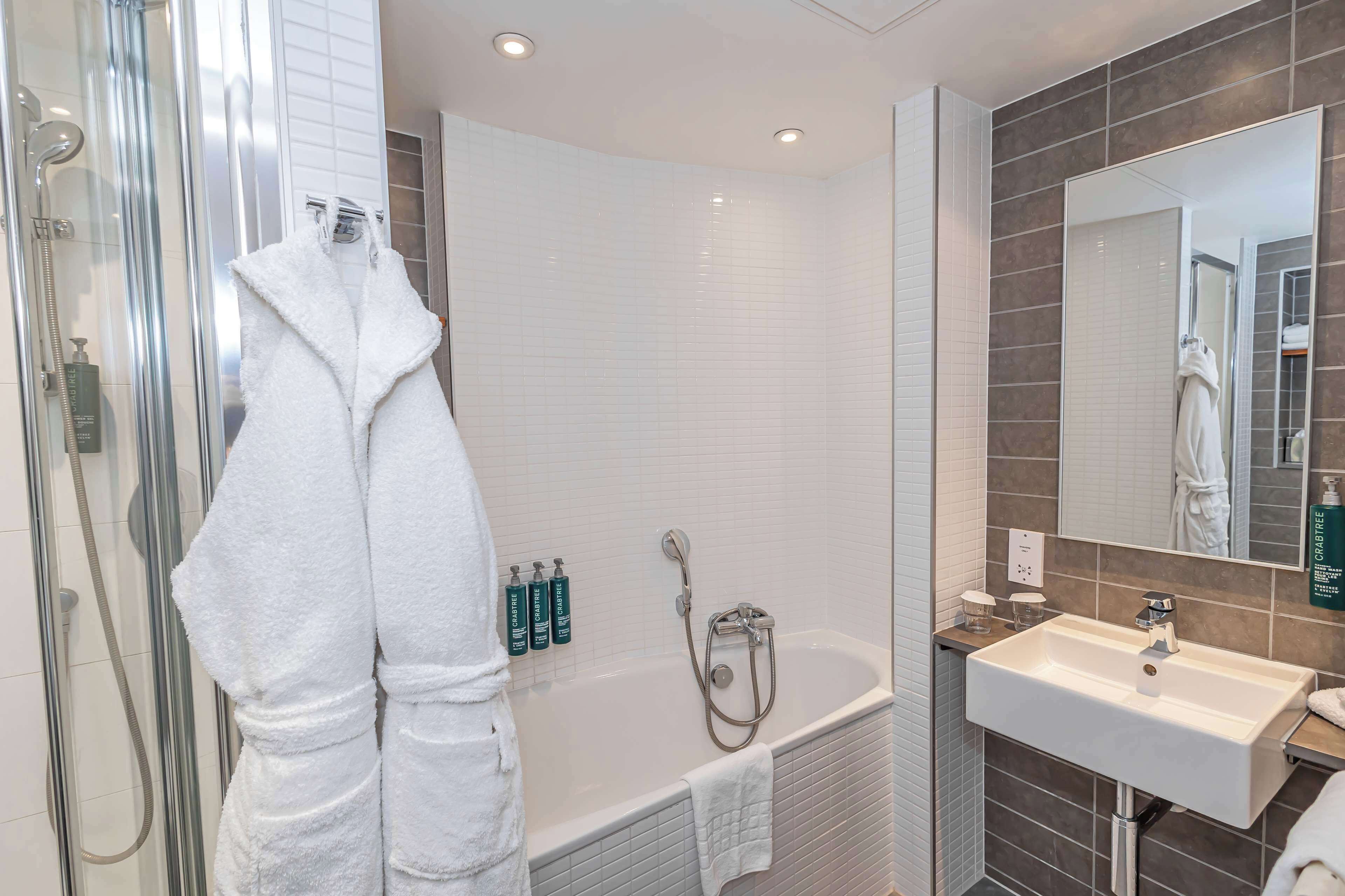 suite, 1 king bed, non smoking (atrium) | bathroom | shower, designer toiletries, hair dryer, towels