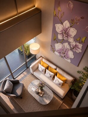 A modern living room with a sofa, armchair, coffee table, and a large window. - Sivatel Bangkok (Bangkok)