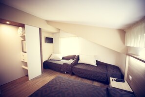 Cozy retreat with a wardrobe, bedside table, and single bed.