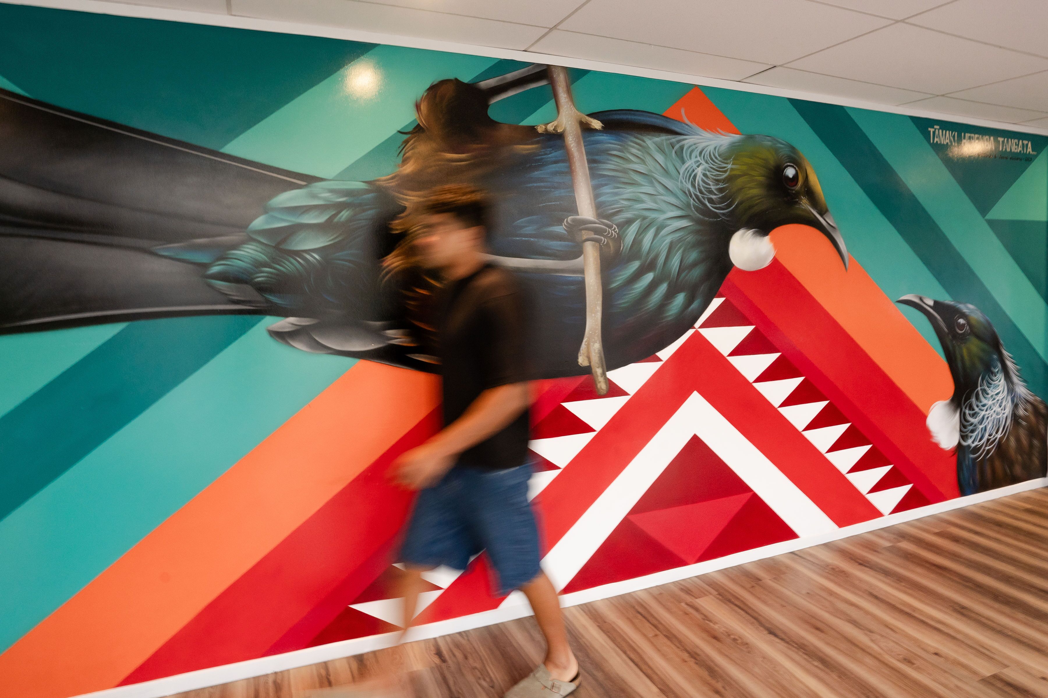 A mural with a large bird and geometric shapes.