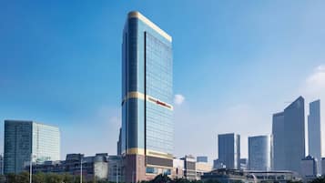 Situated in a bustling urban environment, this high-rise hotel offers a unique corner design and easy access to nearby amenities.