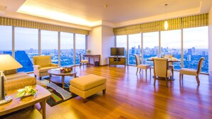 A spacious living room with a city view, a dining area, and a television.