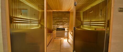 A sauna room with wooden walls and benches.