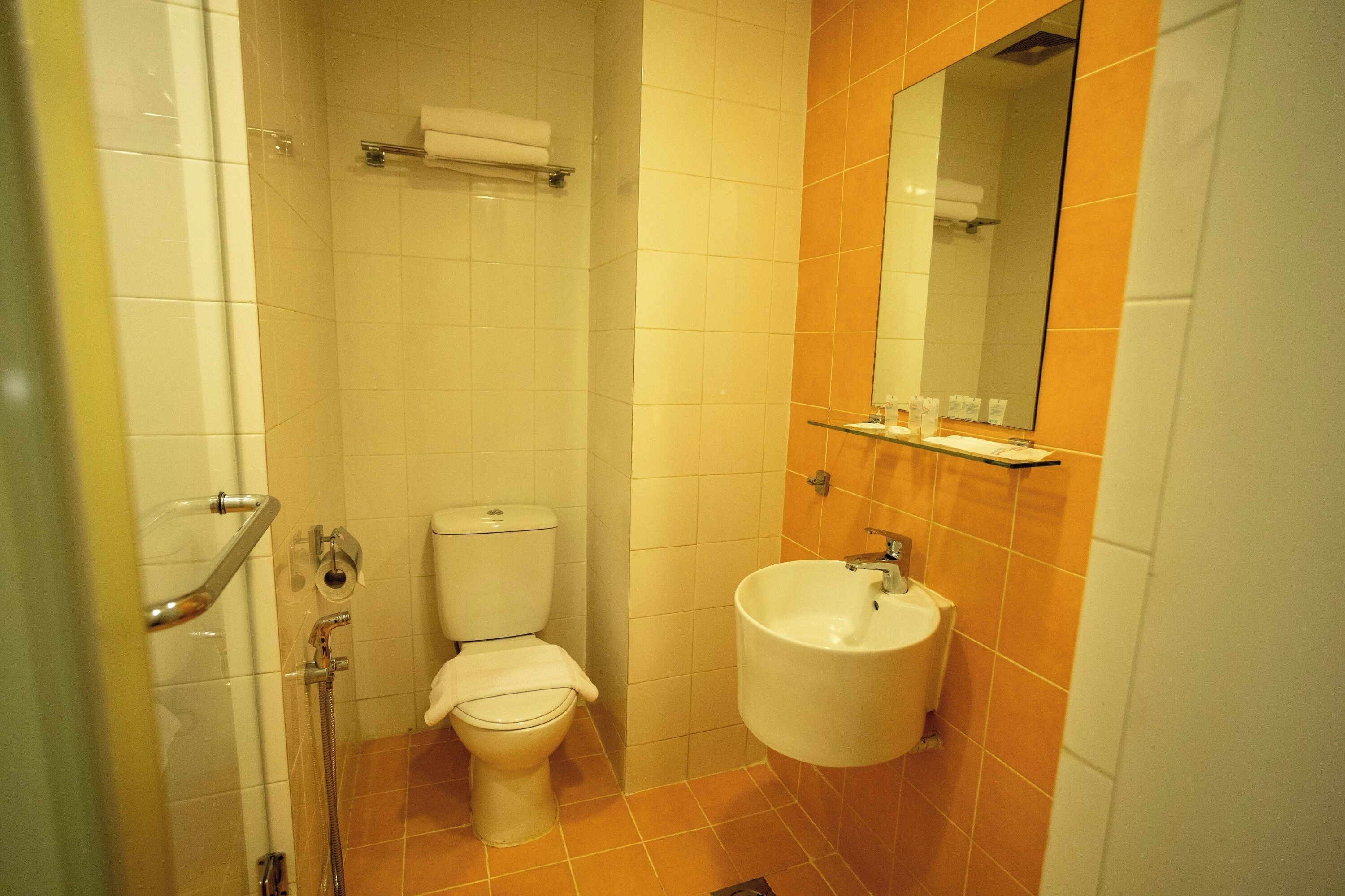 A bathroom with a toilet, sink, and shower.