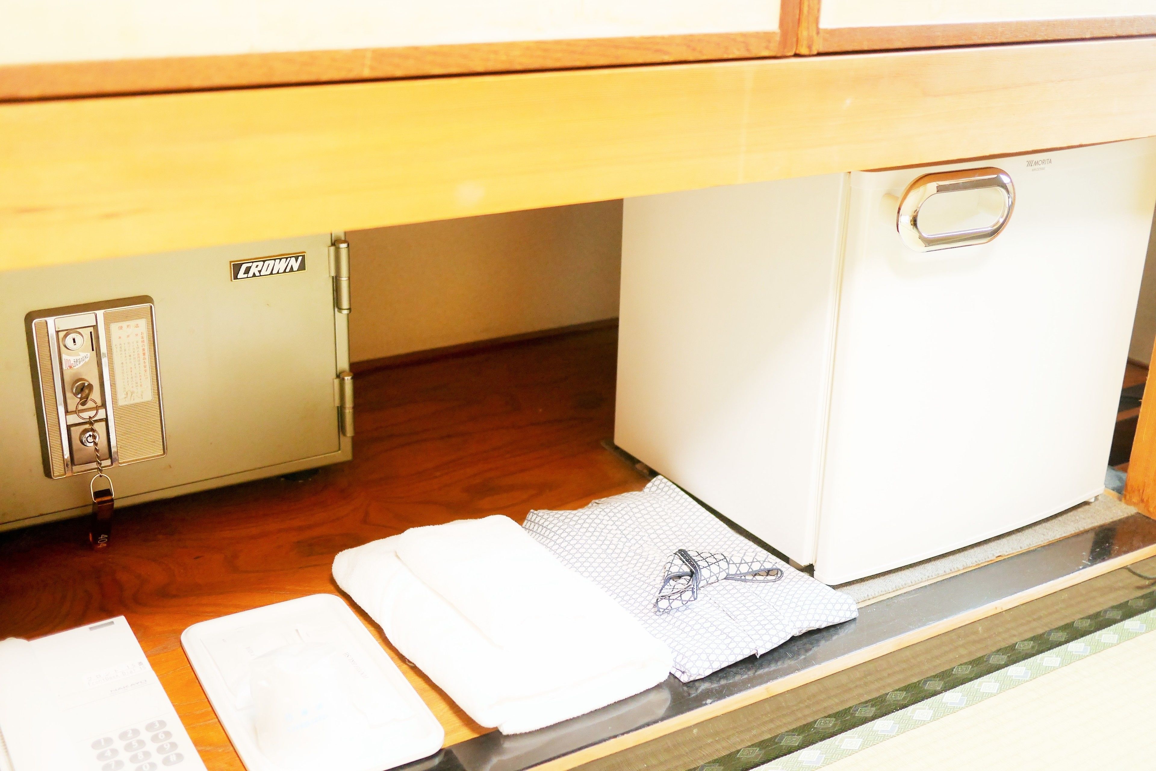 A compact kitchen with a refrigerator, a microwave, and a sink.