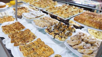 A variety of pastries and baked goods displayed in a bakery setting.