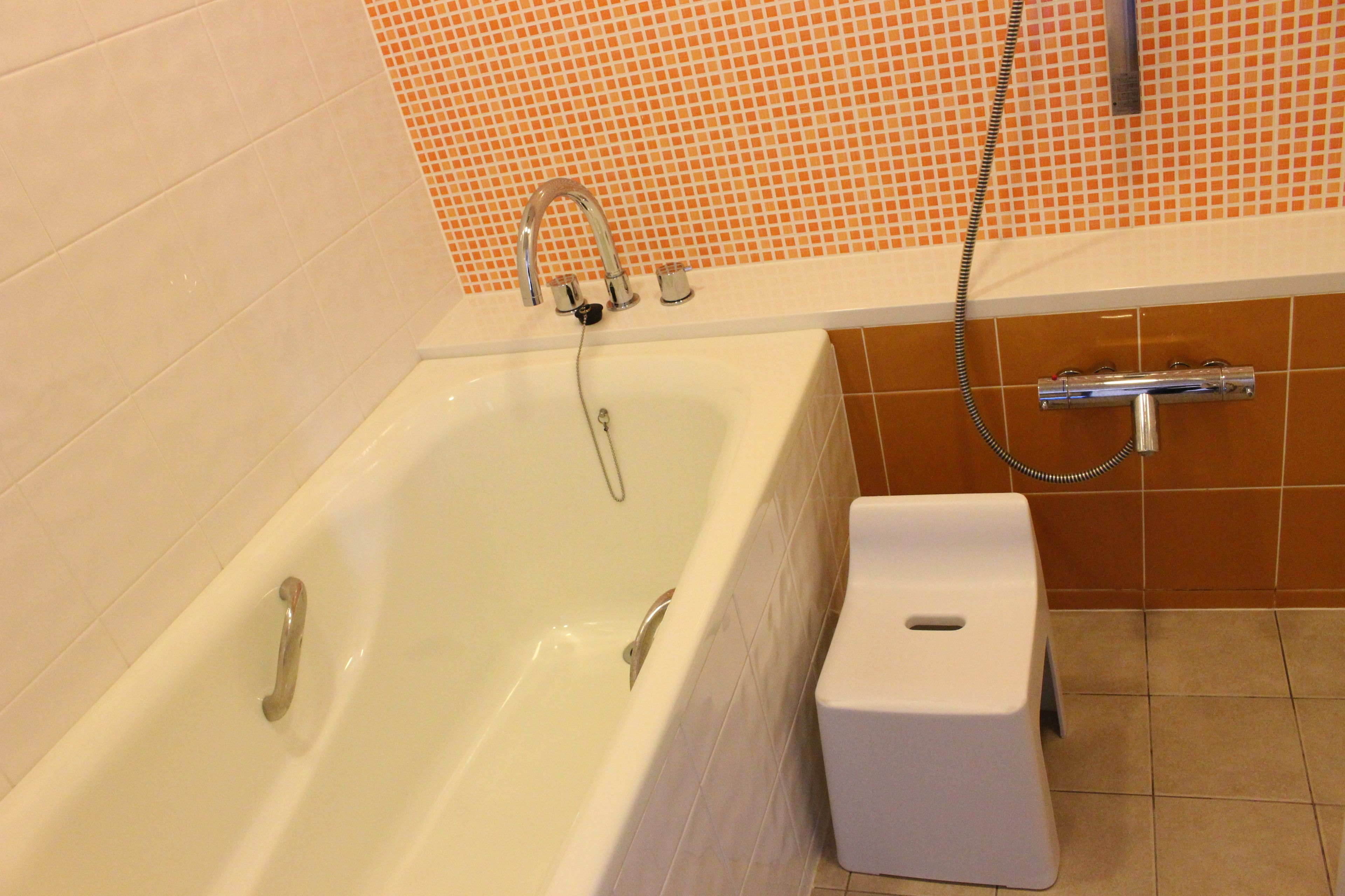 A bathroom with a bathtub, a shower, and a toilet.