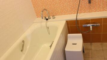 A bathroom with a bathtub, a shower, and a toilet.