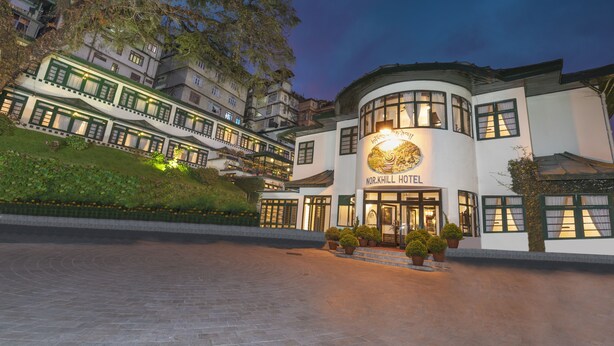 A hotel with a traditional architectural style, featuring multiple stories and a prominent entrance with a sign. - The Elgin Nor-Khill - A Heritage Hotel & Spa (Gangtok)